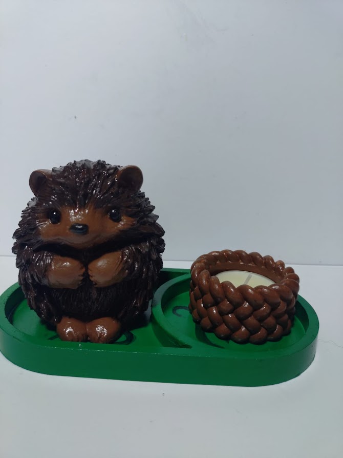 a)Hedgehog and candle on a tray